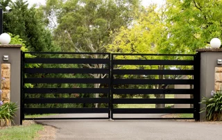 Black,Metal,Driveway,Entrance,Gates,Set,In,Brick,Fence