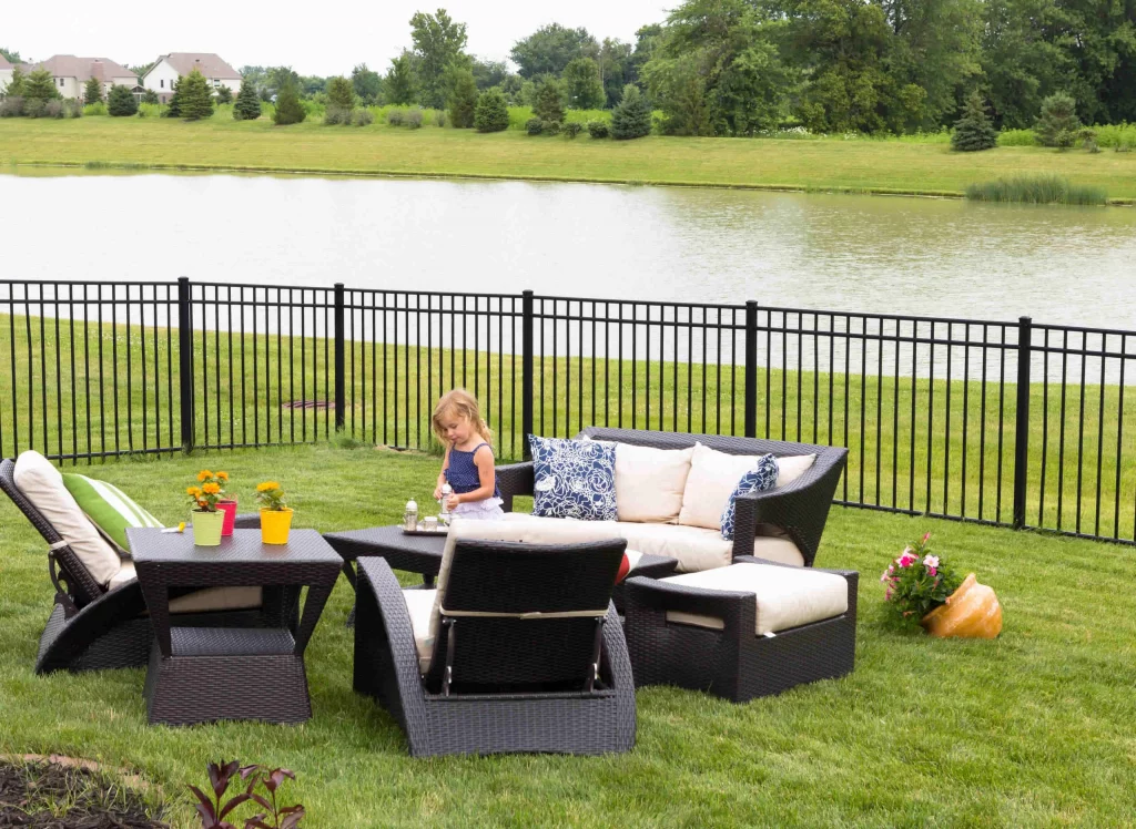 Cute,Little,Blond,Girl,Standing,Amongst,Comfortable,Modern,Design,Garden