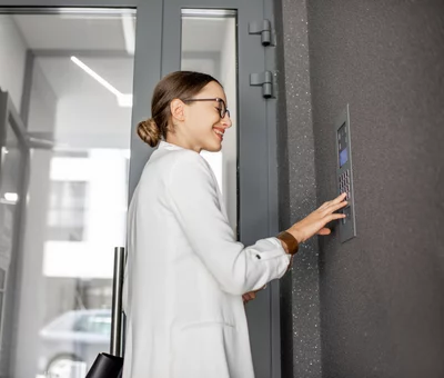 Young,Business,Woman,In,White,Suit,Entering,Code,On,The