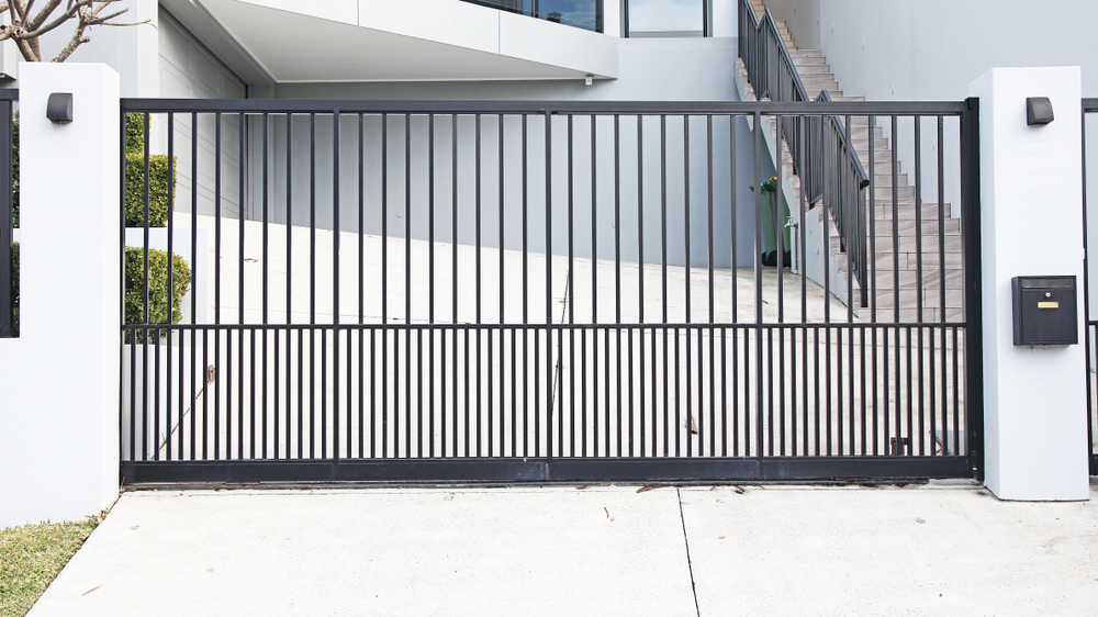 Automatic sliding gate with vertical metal bars (How to Choose the Best Gate for Your Home)