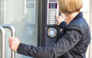 Office lady entering office via intercom system (3 Benefits of Internal Intercom Systems)