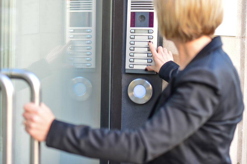 Office lady entering office via intercom system (3 Benefits of Internal Intercom Systems)