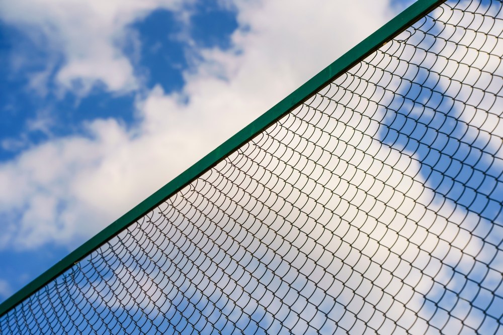 Chain-link,Fence,Against,The,Background,Of,The,Summer,Sky.,Fencing,